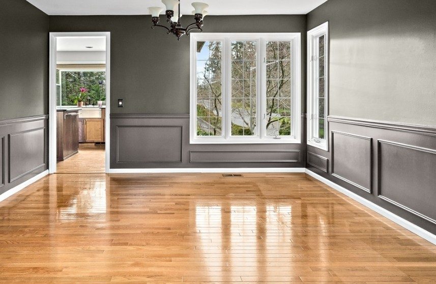 Dining room painted in deep charcoal with two-tone wainscoting